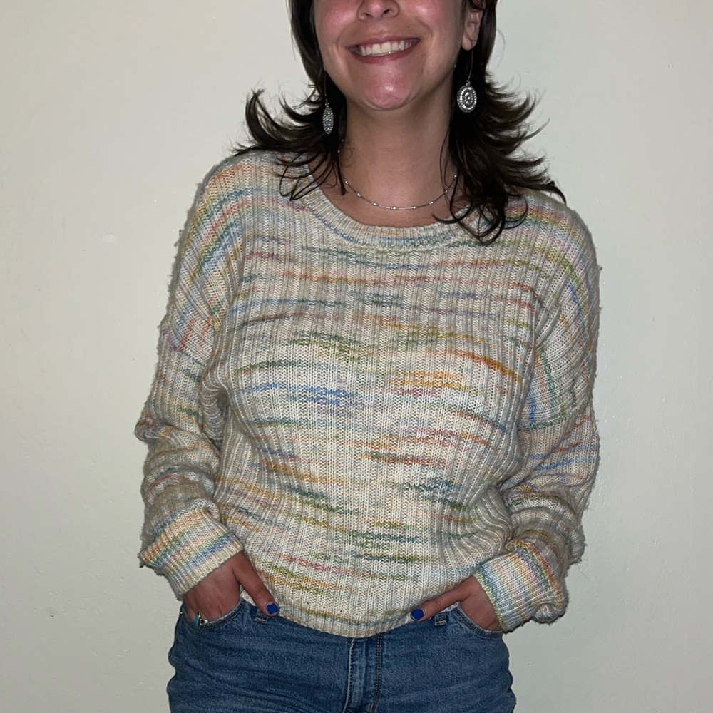 Adorable creme sweater with pastel hues